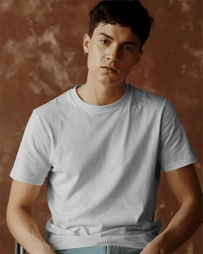 Seated T Shirt Mockup Against Brown Wall Relaxed Look Minimal Style With Modern Fashion Vibes