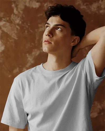 Relaxed Pose T Shirt Mockup With Hand On Neck Earthy Toned Background Clean Modern Minimal Look