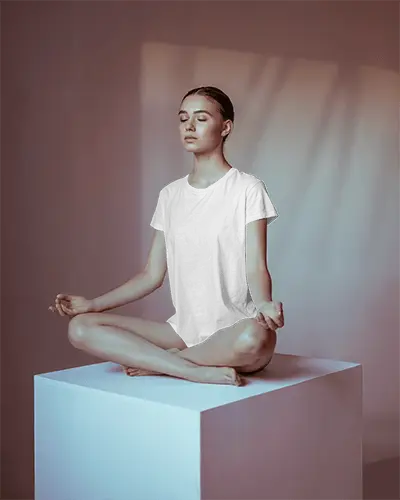 T Shirt Mockup Female Model Sitting In Meditation Pose Soft Studio Lighting Calm Ambience