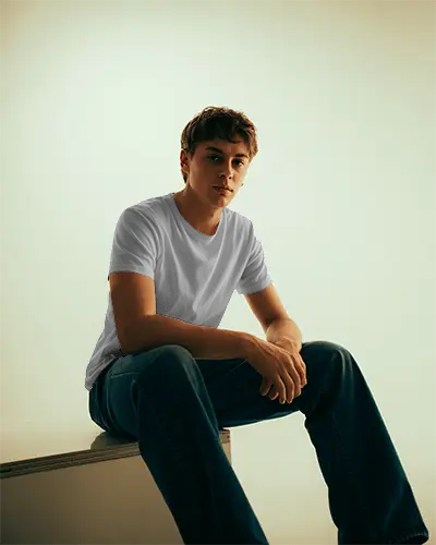 trendy-minimalist-t-shirt-mockup-for-male-model-studio-seated-fashion-portrait