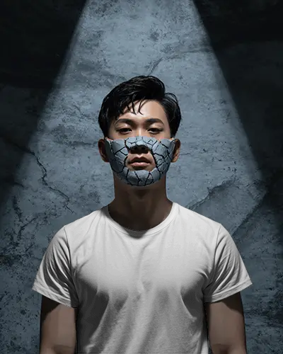 Spotlight Stone Mask T Shirt Mockup Male Model In Moody Shadowed Studio Background