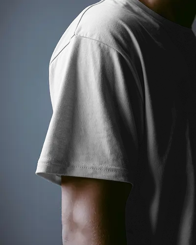Close Up T Shirt Mockup Of Sleeve And Arm In Moody Studio Lighting Minimal Style