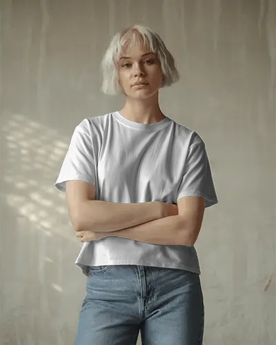 Casual Lifestyle T Shirt Mockup Female Model With Crossed Arms In Soft Natural Light Studio