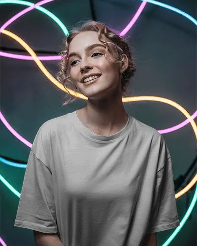 Neon Lights Tshirt Mockup Female Model Smiling In Studio With Colorful Modern Light Rings