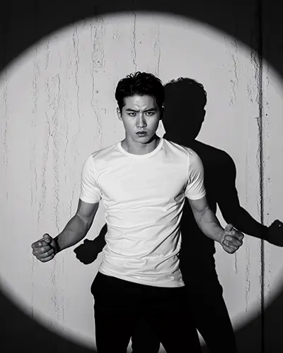 Dramatic Spotlight T Shirt Mockup Male Model In Black And White Studio Scene With Shadows