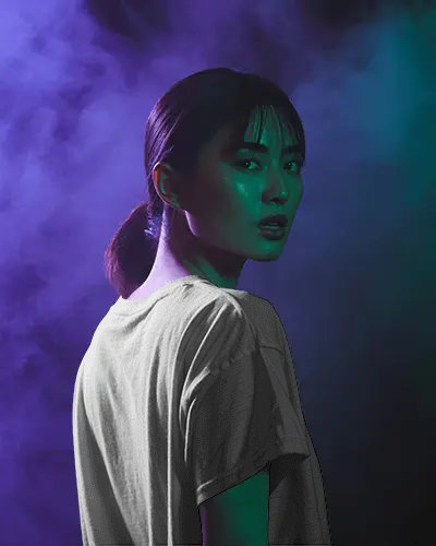 Neon Mist T Shirt Mockup Female Model In Studio With Purple And Green Smoky Light Effects