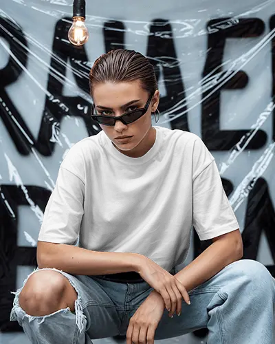 Urban Attitude Tshirt Mockup Female Model In Ripped Jeans Against Graffiti Backdrop