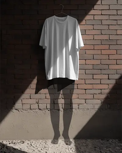 Sunlight And Shadows Tshirt Mockup Hanging Tee On Brick Wall In Industrial Minimal Setup