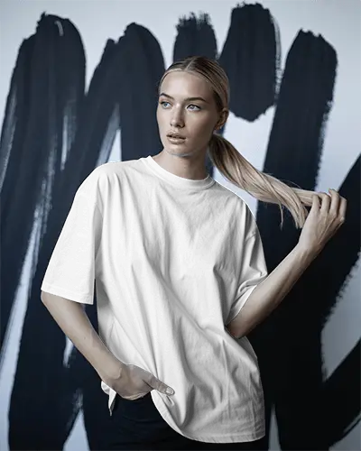 Tshirt Mockup Female Model Posing With Hair Against Abstract Brush Art Wall