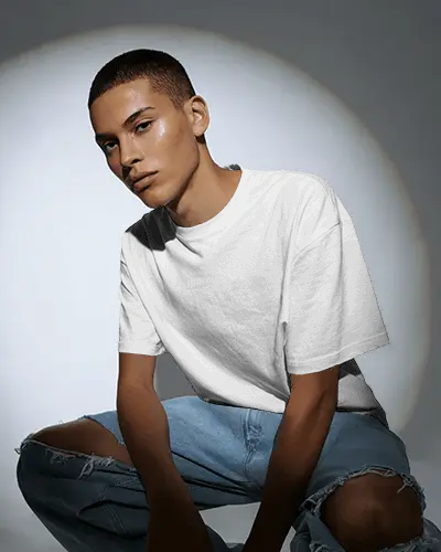 Urban Studio T Shirt Mockup Male Model Sitting Under Spotlight Modern Casual Look