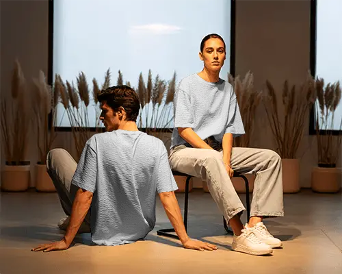 Minimalist Duo Tshirt Mockup Male And Female Models In Warm Studio Interior Setting