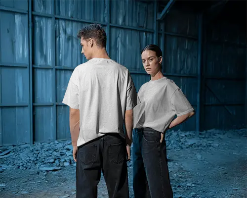 Moody Industrial Tshirt Mockup Male And Female Models In Blue Toned Warehouse Setting