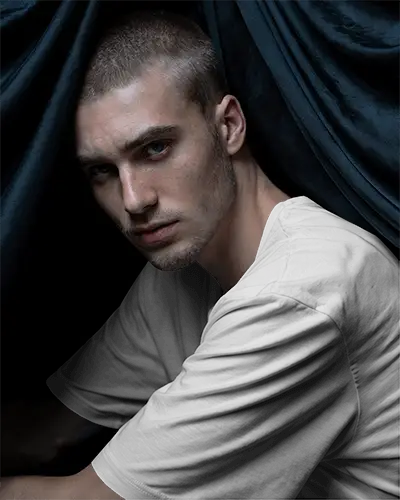 Closeup Of Men Tshirt Mockup In Comfortable Tee Around Dark Drapes Fashionable And Simple Look