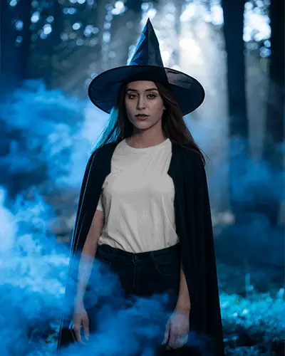 Enchanting Forest Witch In Halloween Tshirt Mockup And Hat Surrounded By Mystical Foggy Atmosphere