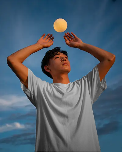 Simple Basic Crewneck Tshirt Mockup For Young Male Model On Cloudy Blue Sky Background