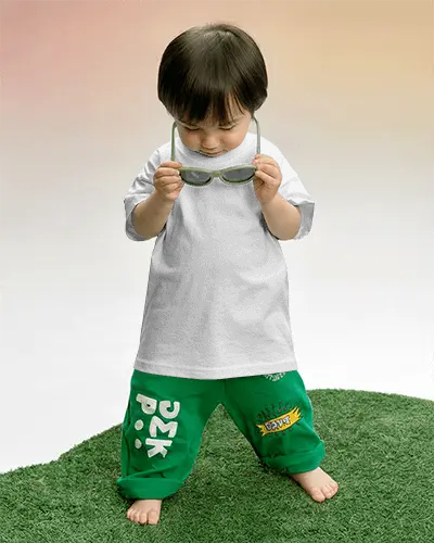 Kids Tshirt Mockup Child Looking Down Holding Glasses On Green Grass Set Studio Environment