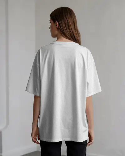 Back View T Shirt Mockup Female Model In Soft Natural Interior Lighting