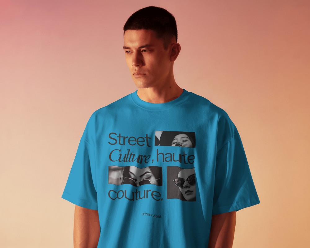 Soft Gradient Background Mockup Front View Of Blank Oversized T Shirt On Male Model Looking Downward With Relaxed Expression Against Warm Toned Backdrop Showcasing Simple Yet Stylish Look