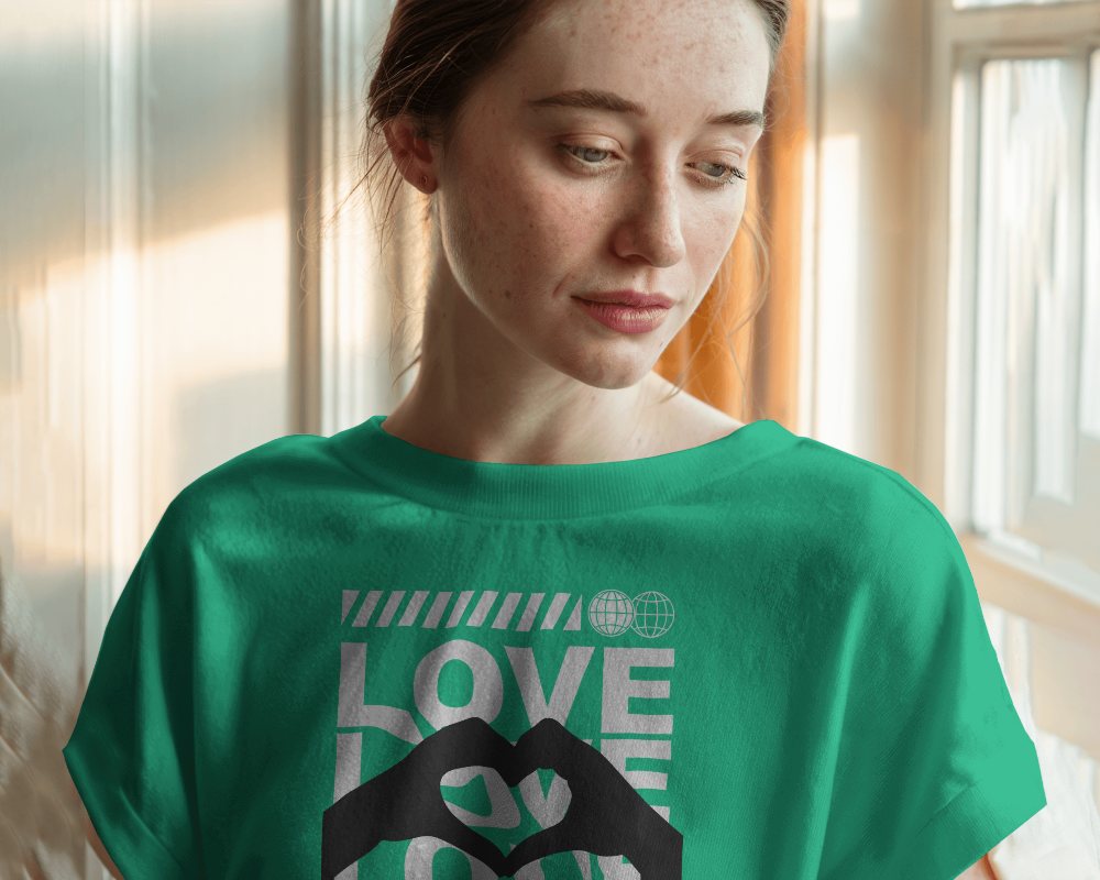 Sunlit Interior T Shirt Mockup Female Model Looking Down In Soft Warm Lighting Casual And Peaceful Ambience