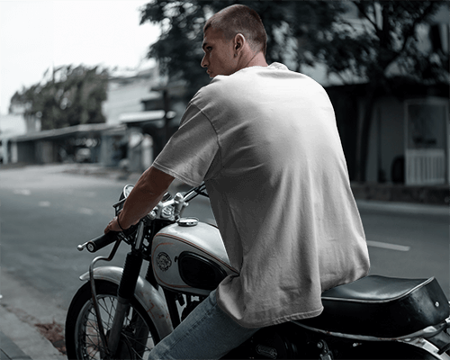 Street Scene T Shirt Mockup Young Man Wearing T Shirt Sitting On Motorcycle With Light Plain T Shirt And Blurred Background