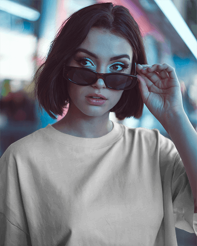 Urban Night T Shirt Mockup Female Model With Short Hair Adjusting Sunglasses In City Light Background