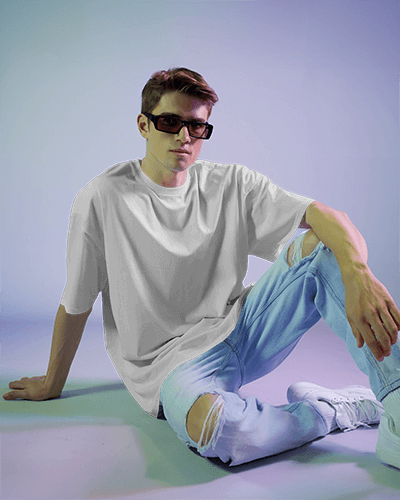 Retro Casual T Shirt Mockup Male Model Sitting In Vibrant Studio Lighting