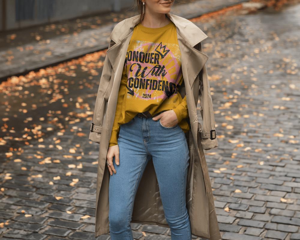 American Model T Shirt Mockup Female Standing On Cobbled Street Autumn Styling With Trench Coat Cozy And Chic Vibes
