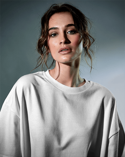 Focused T Shirt Mockup Female Model In Dramatic Studio Lighting