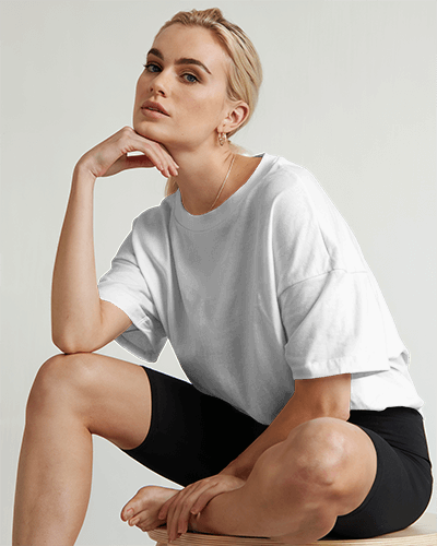 Studio Lighting T Shirt Mockup Blonde Female Model In White Oversized Tee And Black Shorts Modern And Chic 0584