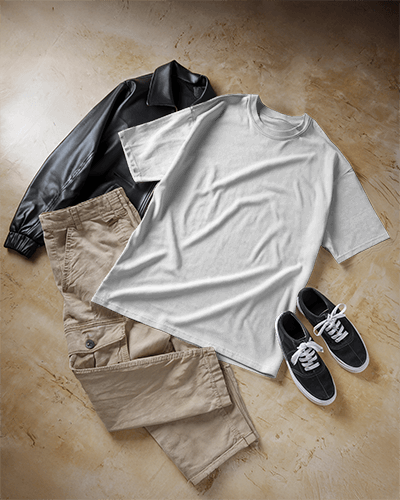 Flat Lay T Shirt Mockup With Casual Outfit Black Leather Jacket Khaki Pants And Sneakers On Textured Floor Modern And Stylish Ensemble 0633