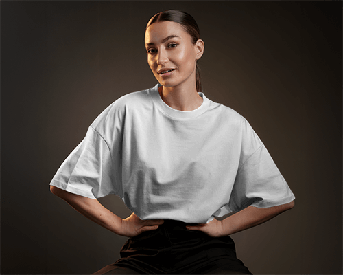 Studio Portrait T Shirt Mockup Female Model In Oversized Fit Hands On Hips Moody Lighting Modern And Confident Look 0635