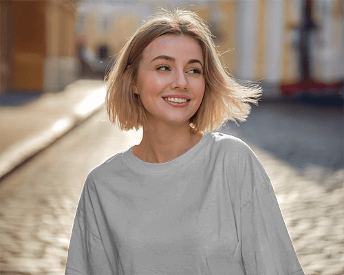 Sunlit Street T Shirt Mockup Smiling Female Model Flowing Hair Warm Golden Hour Lighting Casual And Carefree Ambience 0654