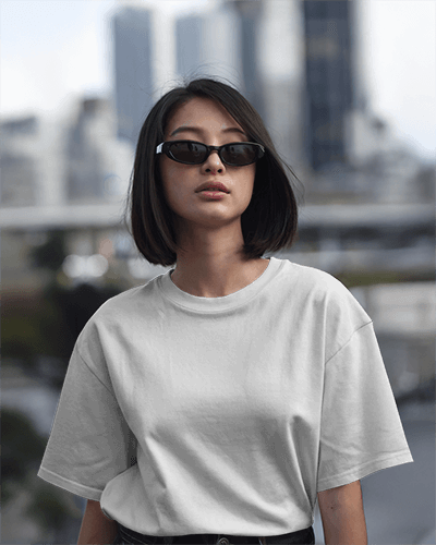 Urban Stylish Blank Asian Women Oversized Round Neck T Shirt Mockup Female Model With Black Bob And Sunglasses Cityscape Background 0780