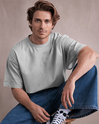 Relaxed Studio Blank Round Neck T Shirt Mockup Male Model In Light Gray Oversized Tee Casual Pose Soft Neutral Background 0824