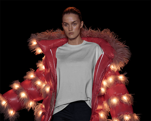 High Fashion Runway T Shirt Mockup Female Model In Illuminated Red Puffer Jacket Bold And Futuristic Aesthetic 0866