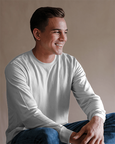 Neutral Toned Long Sleeve T Shirt Mockup Smiling Male Model Relaxed Pose Soft Lighting And Casual Modern Vibe 0878