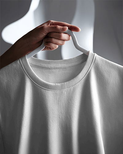 Close Up Hanging Round Neck T Shirt Mockup Hand Holding White Hanger In Soft Shadow Lighting Minimal And Clean Detail Focused View 0899