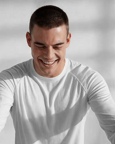 Sunlit Long Sleeve T Shirt Mockup Male Model Smiling In Natural Light White Background Clean And Happy Vibe With Texture Detail 0901