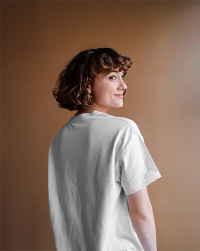 Backview White Tshirt Mockup On Smiling Female Model Soft Brown Studio Background