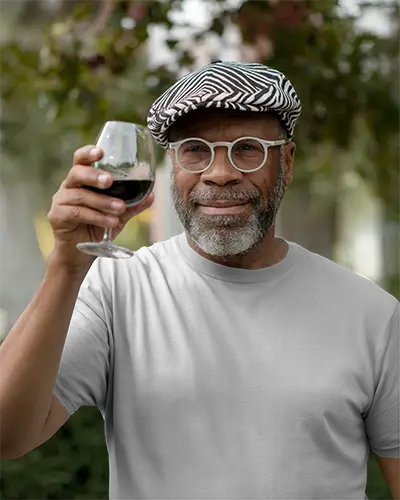 Lifestyle Mens Tshirt Mockup Older Gentleman In Striped Flat Cap Outdoor Bokeh Background Warm And Joyful Tone