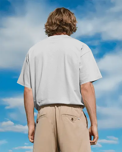 Outdoor Back View T Shirt Mockup Male Model Wearing Boxy White Tee Under Clear Blue Sky Relaxed Summer Vibe