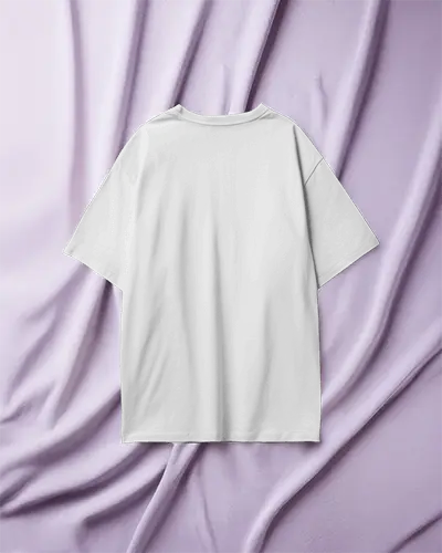 Back View T Shirt Mockup Boxy White Tee Laid On Soft Lavender Fabric Draped Elegant Background Clean And Stylish Presentation