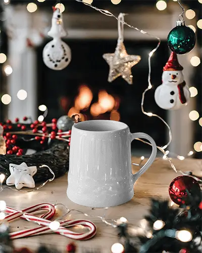 Festive Holiday Mug Mockup White Coffee Cup With Design Space On Table Accented By Christmas Decorations And Fireplace Warm And Jolly Ambience
