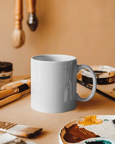 Creative Studio Mug Mockup White Coffee Cup With Design Space On Art Desk Accented By Paintbrushes And Colorful Palette Inspiring And Artistic Atmospherecreative Studio Mug Mockup White Coffee Cup With Design Space On Art Desk Accented By Paintbrushes And Colorful Palette Inspiring And Artistic Atmosphere