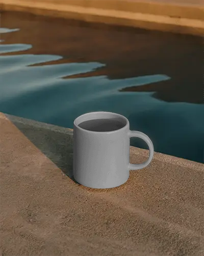 Outdoor Coffee Mug Mockup With Smooth Texture Placed On Rough Concrete Near Water 0208