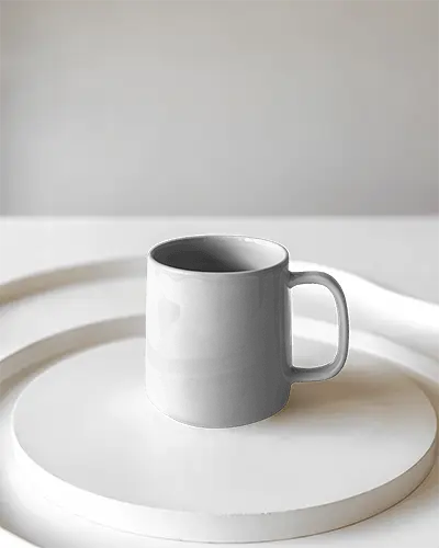 ceramic-coffee-mug-on-modern-minimalist-round-plate-for-custom-branding-display