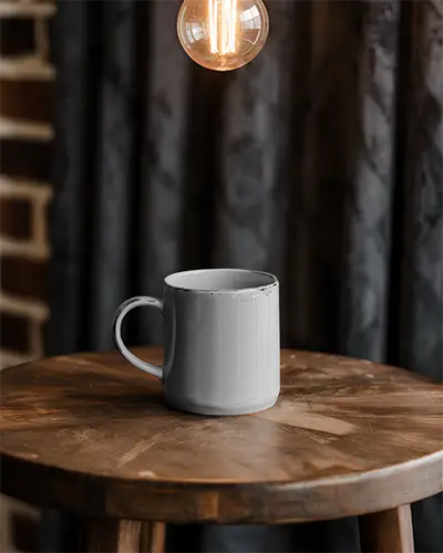 rustic-coffee-mug-mockup-with-wooden-table-and-industrial-lighting-setup