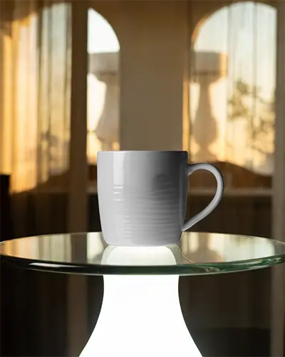 empty-minimalist-style-mug-mockup-on-glass-surface-with-blurred-window-background
