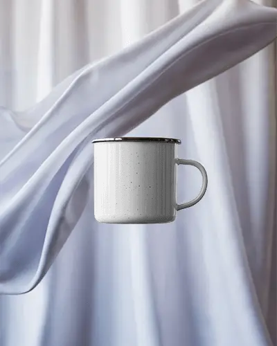 vintage-metal-enamel-mug-mockup-with-circular-handle-floating-against-soft-fabric-background