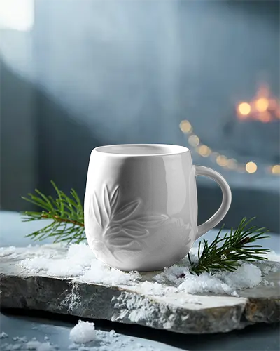 Artisanal Winter Mug Mockup Displayed On Natural Rock Surface Surrounded With Evergreen Branch